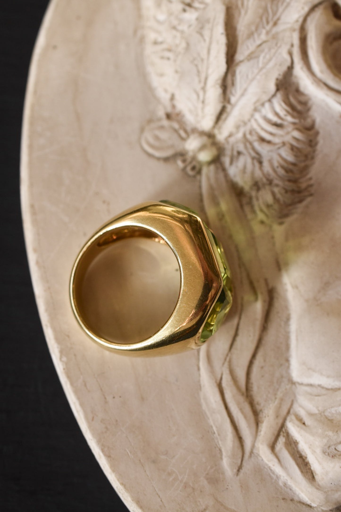 A Large Channel-set Peridot and 18K Gold Trilogy Ring