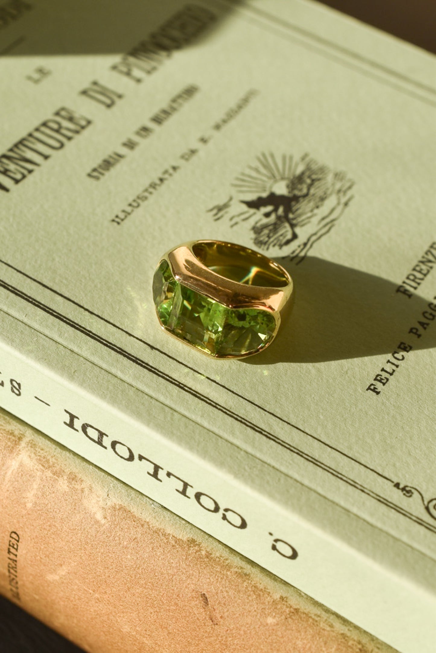 A Large Channel-set Peridot and 18K Gold Trilogy Ring